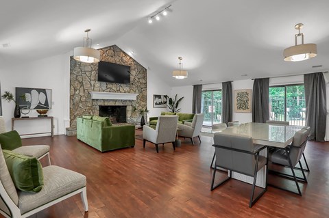 a living room with a table and chairs and a fireplace